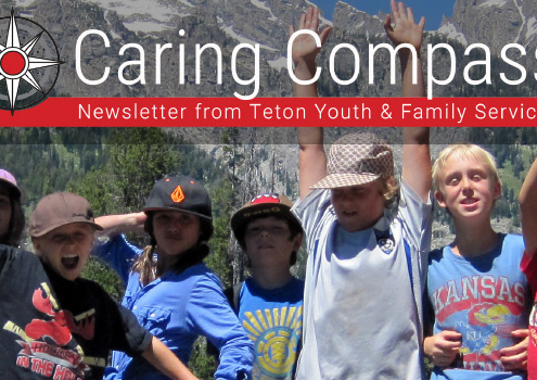 Fall_2019 newsletter featured image_kids with hand in the air in front of the Tetons