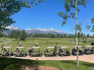 Golf carts parked in front of the tetons