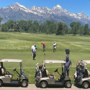 People playing gold under the tetons